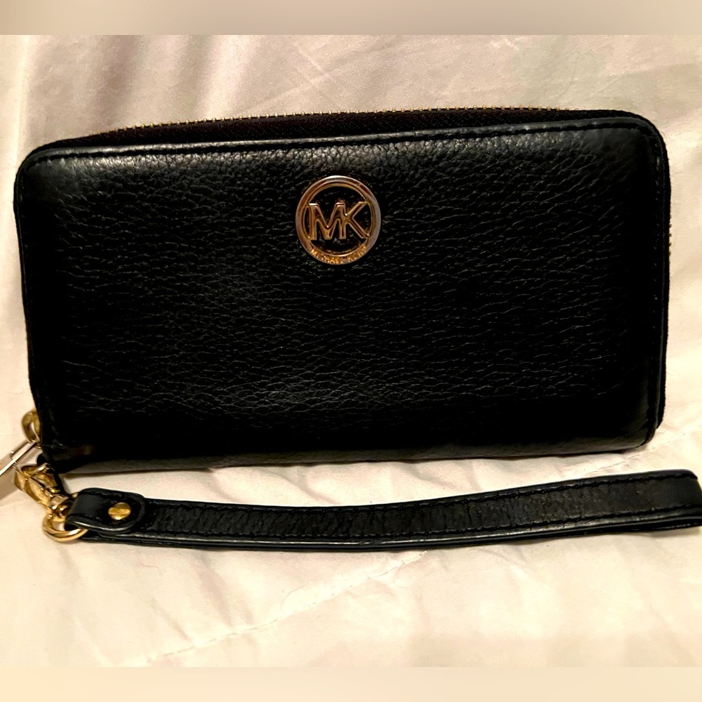 Michael Kors Woman’s wallet, black leather with gold accents .